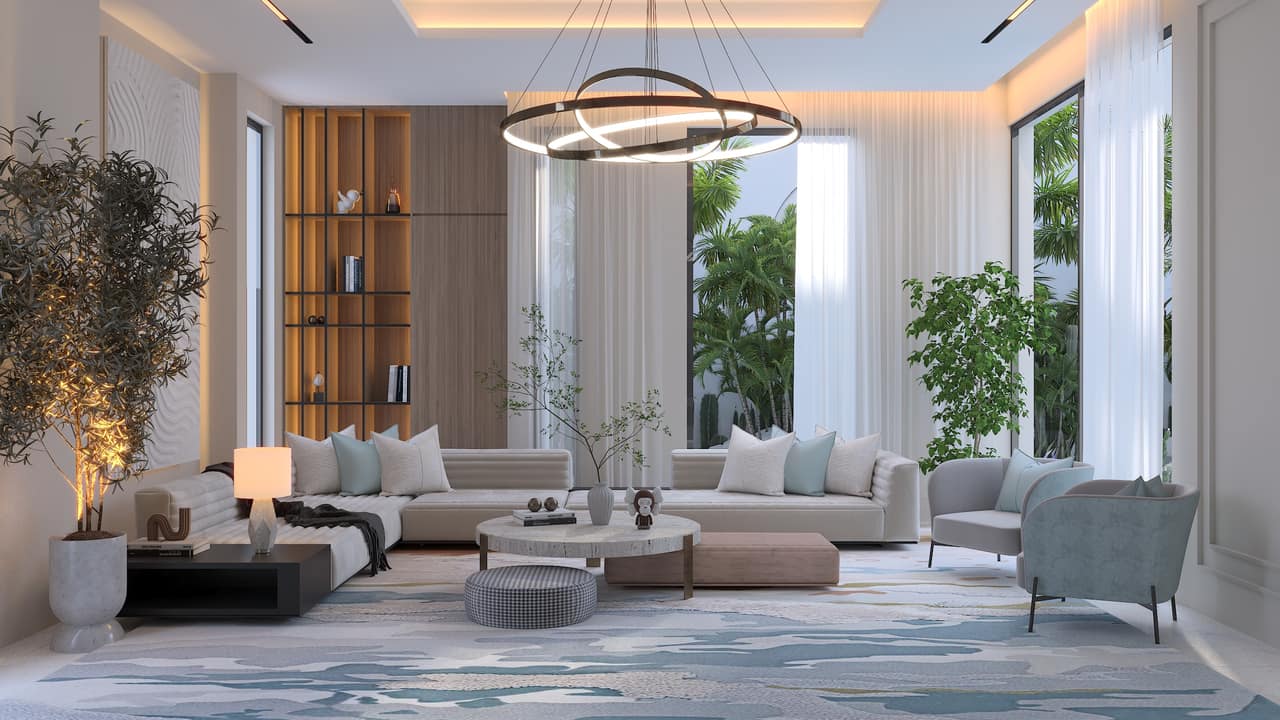 A sitting room lit in separate layers: a suspended ring at the centre, a concealed strip along the ceiling edge, a table lamp, and daylight from tall windows behind sheer curtains, over pale sofas and a pale-blue armchair.